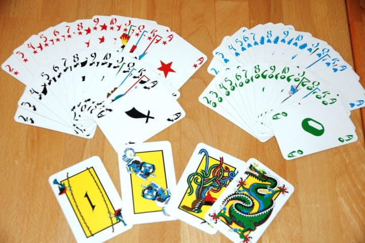 The Tichu deck spread on a table: the four suits and, in front, the four special cards